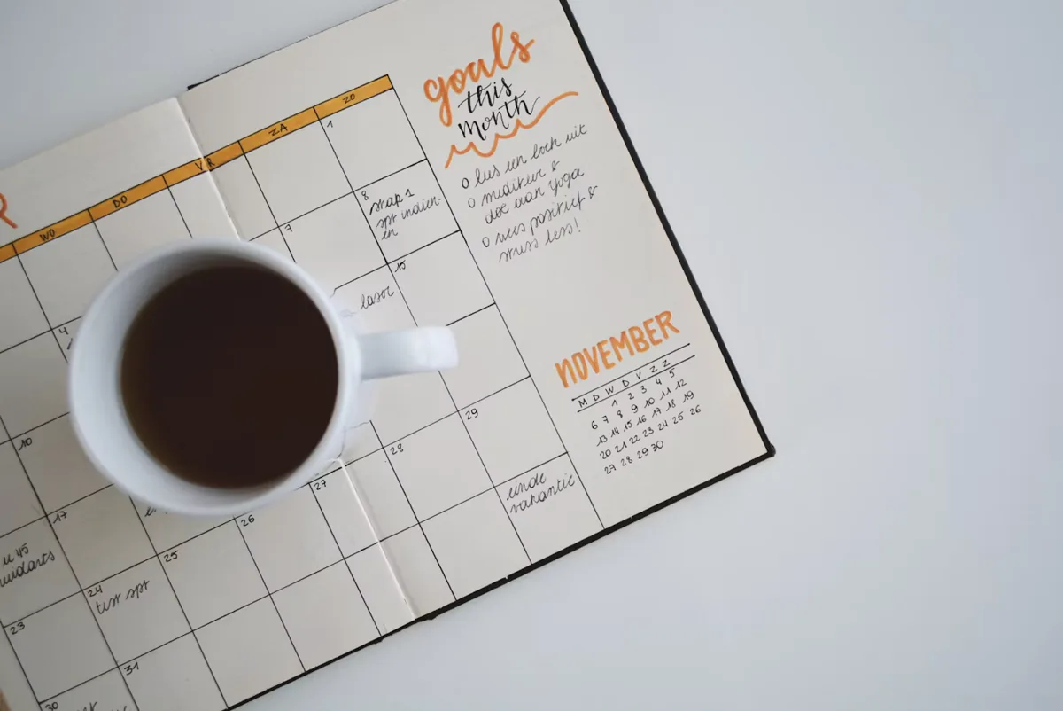 コーヒーカップと予定を書き込んだ手帳